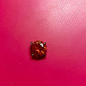 I am selling a ruby with a little ring/hoop around it.